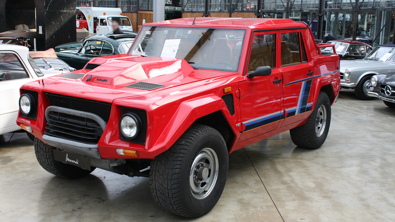 A red Lamborghini LM002 on a showroom floor