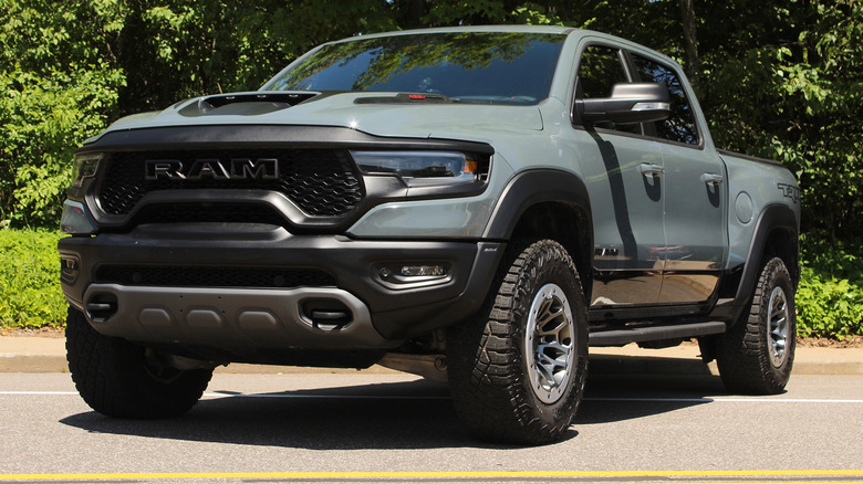 A matte gray 2021-22 Dodge Ram TRX next to trees