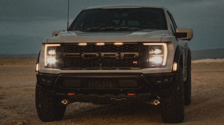A Ford Raptor R parked in the dirt at night