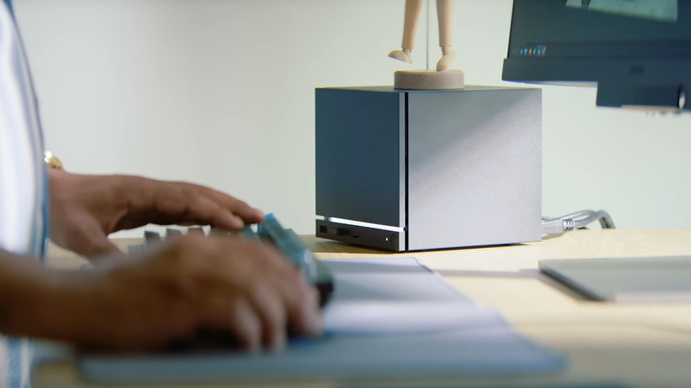 Man using a Steam Machine at desktop with keyboard, mouse, and monitor