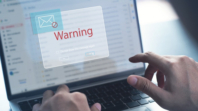 person blocking spam laptop illustration