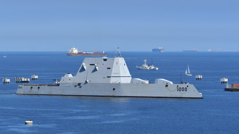 The USS Zumwalt DDG-1000 stealth destroyer pictured here close to other ships in the background.