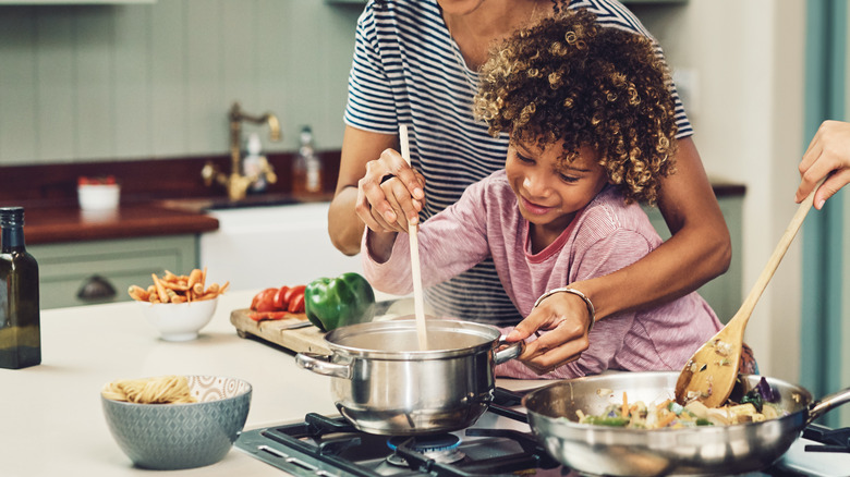 People cooking in the kitchen.