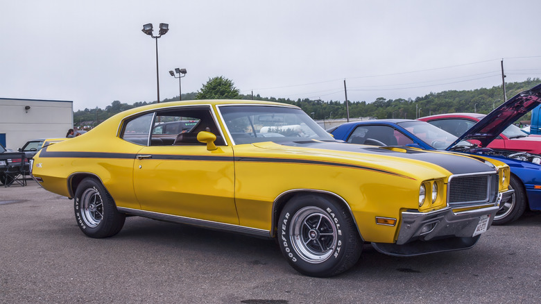 Yellow 1970 Buick GSX parked in lot, front-right 3/4 view