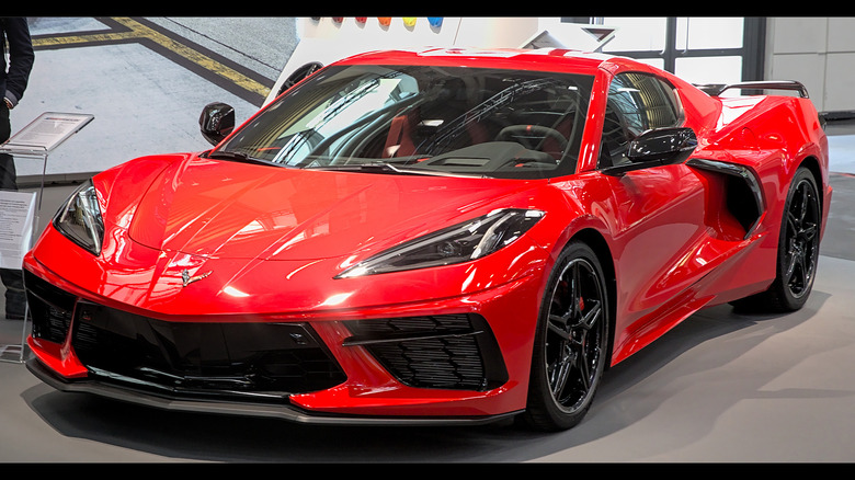 A red Corvette on a showroom floor