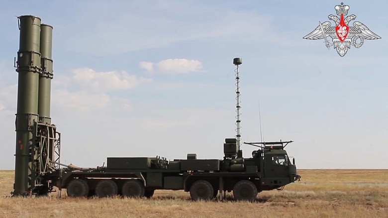An S-500 Prometheus anti-air missile system parked on a field with its launchers erect