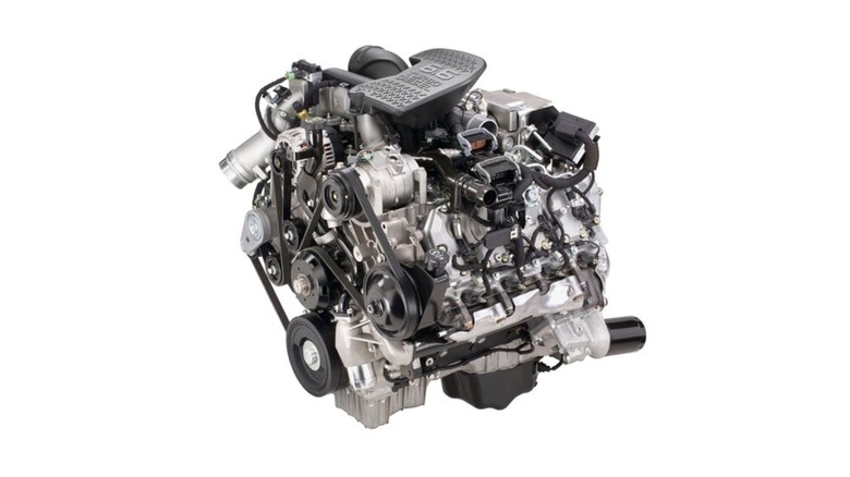 A standalone GM 6.6L Duramax LBZ diesel engine, showing its turbocharger, belt drive, and compact V8 configuration against a plain white background.