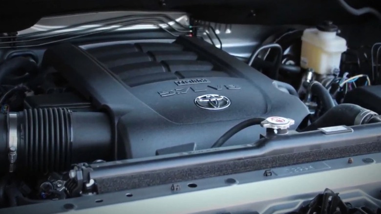 the engine bay of a Heavy Duty pickup truck with its hood open, highlighting the 5.7L i-Force V8 engine and surrounding components.