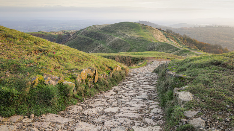 A paved road leading down into the hills