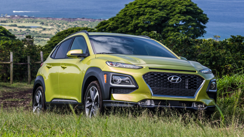 A green 2019 Hyundai Kona on a hilltop.