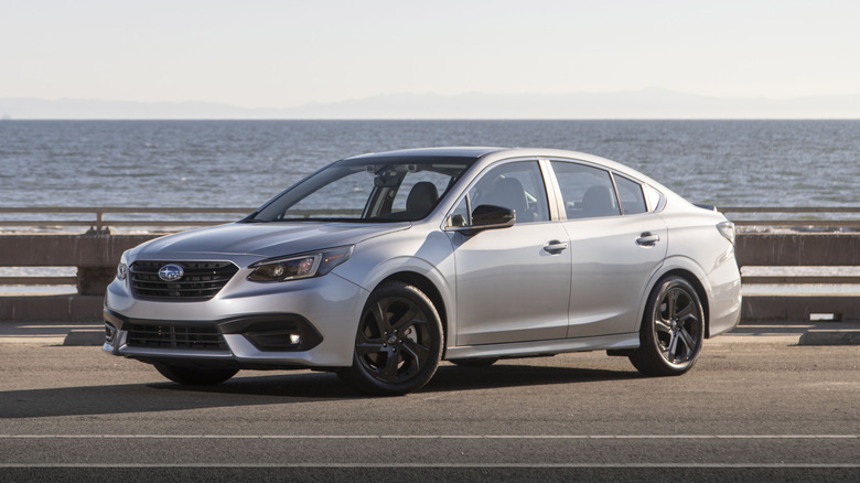 A silver 2020 Subaru Legacy parked alongside a railing.