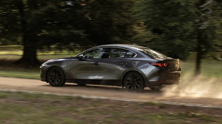 Mazda Mazda3 Sedan driving on a dirt road