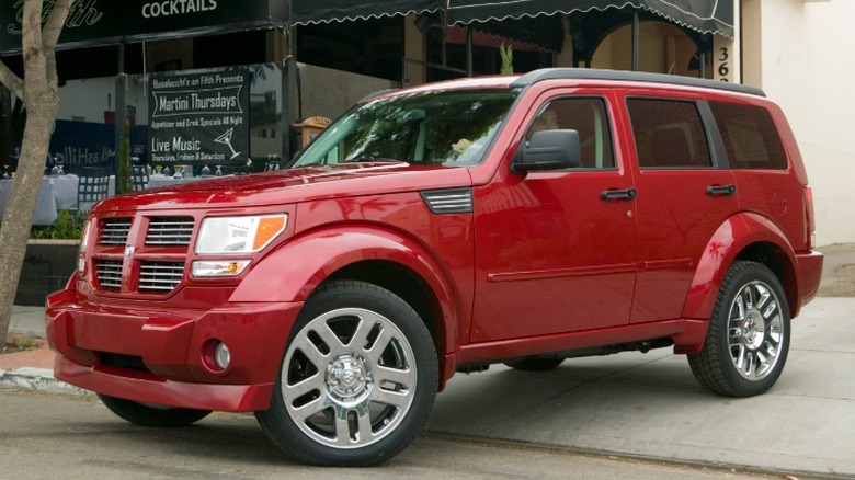Red Dodge Nitro exiting a driveway