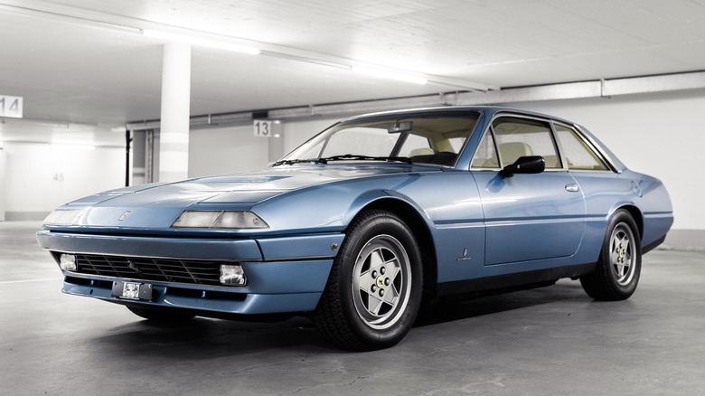 Blue Ferrari 412 in a brightly-lit parking garage