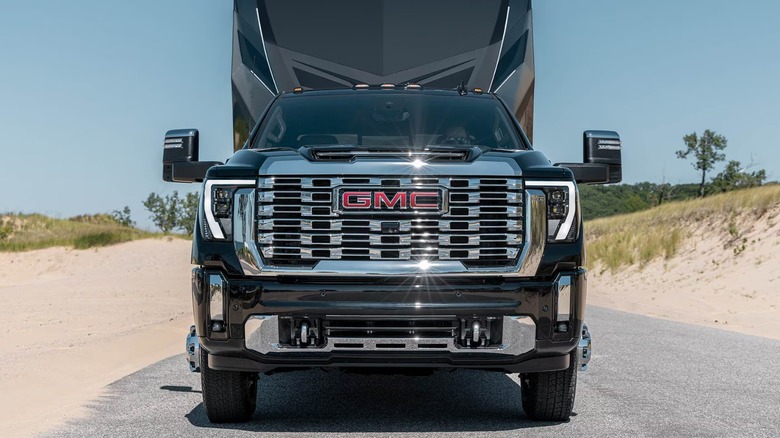 Frontal view of a black GMC Sierra HD parked with a trailer