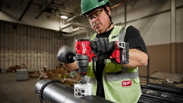 Milwaukee power tool being used by a worker.