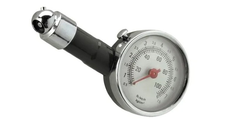 A black and silver tire pressure gauge with analog dial