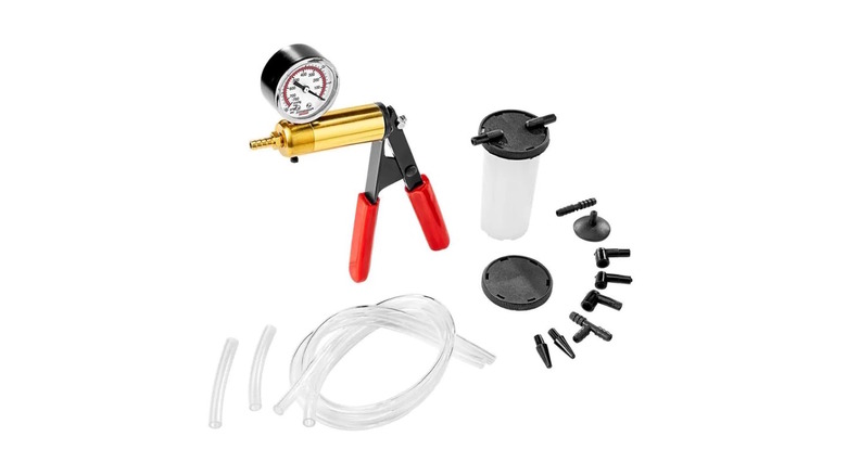 A manual brake bleeder hand pump with hoses and fittings