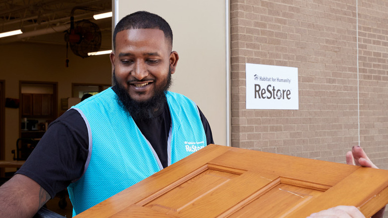 Person taking a donated door out of a ReStore.