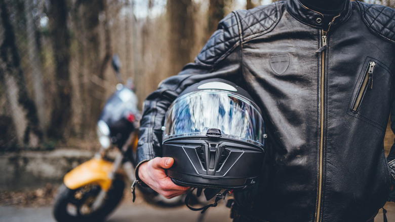 Person holding motorcycle helmet