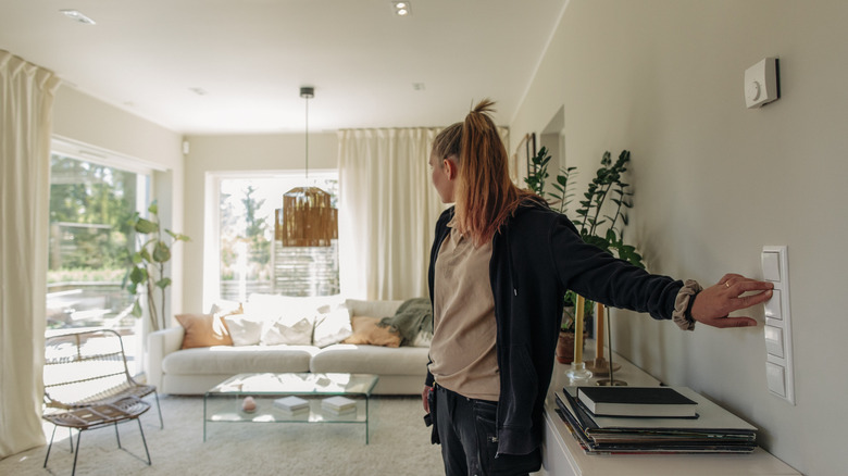 woman hitting the light switch