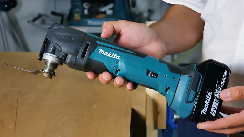 Holding Makita oscillating multi-tool