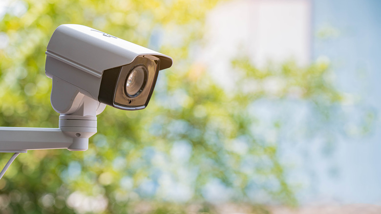 White colored surveillance camera.