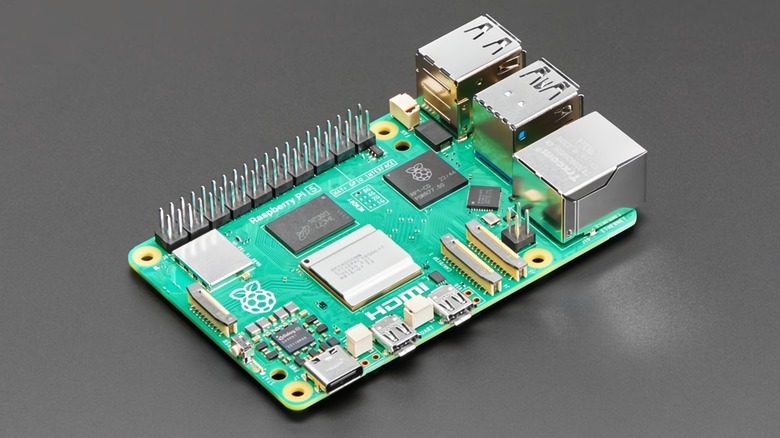 A Raspberry Pi 5 on a gray surface.