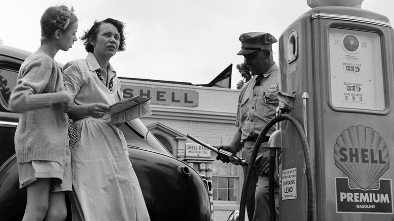 three people at gas station