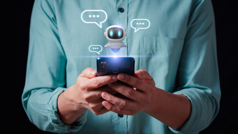 Person holding a phone with a hovering chatbot