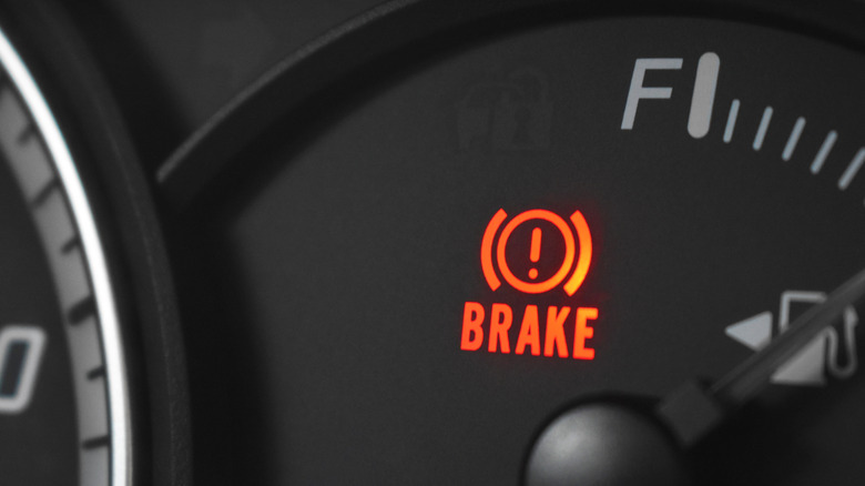 Closeup shot of the red brake light turned on in a car's dashboard