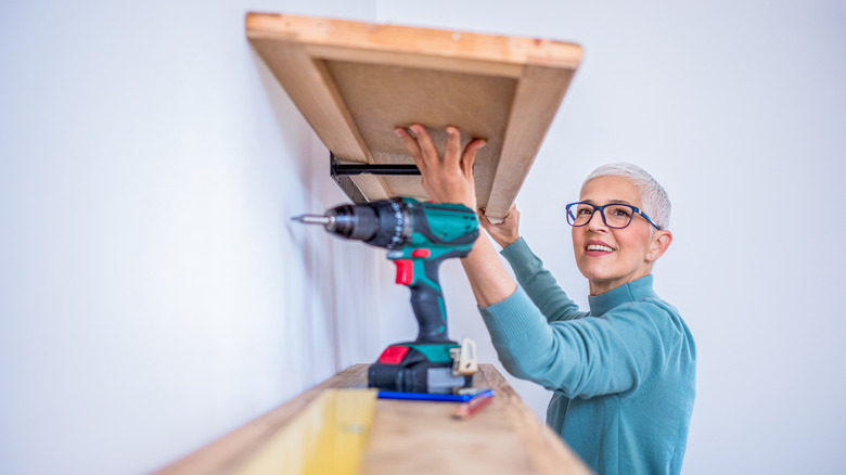 Person installing shelf