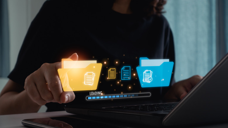 Illustration of data backup overlayed on a person using a laptop