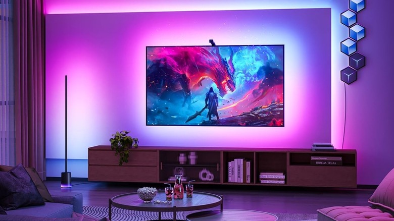 A TV mounted on a wall with colored LEDs around it