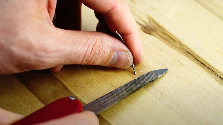 man creating ridges on needle