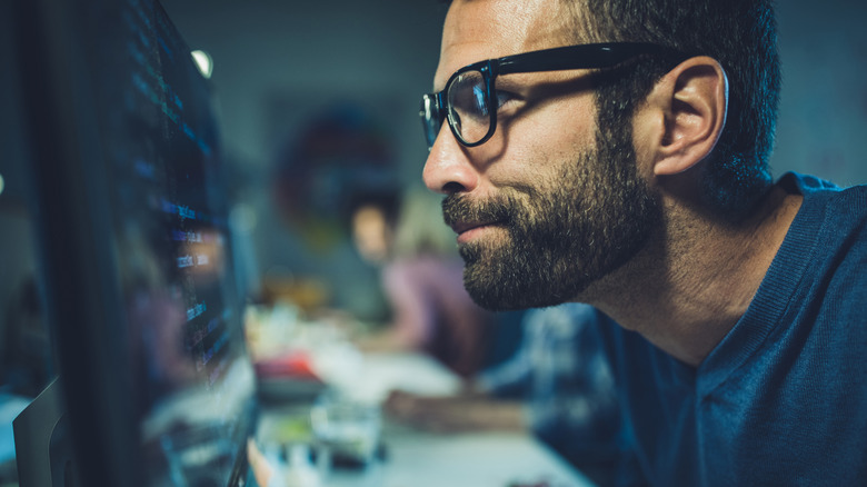 Person staring intently at a computer screen