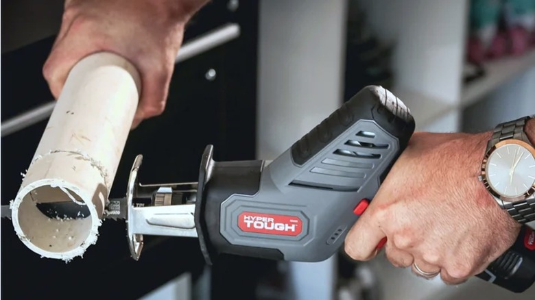 Person using  Hyper Tough Reciprocating Saw