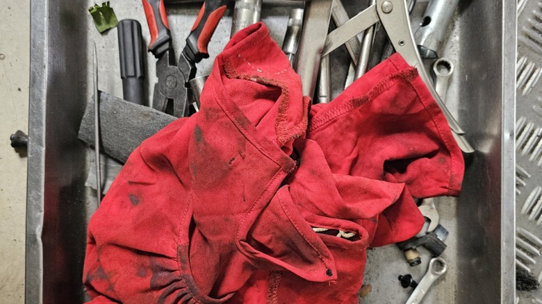 an oily rag on top of some tools
