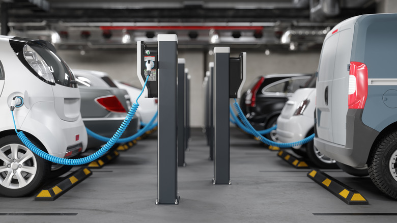 A side view of underground parking with EVs plugged for charging