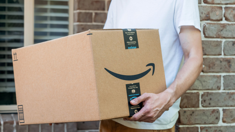 Man holding Amazon delivery box