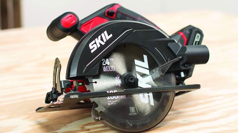 Red and black Skil saw sitting on a wooden countertop