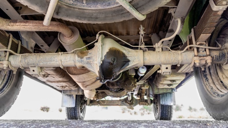 A car's undercarriage showing a leaking rear differential