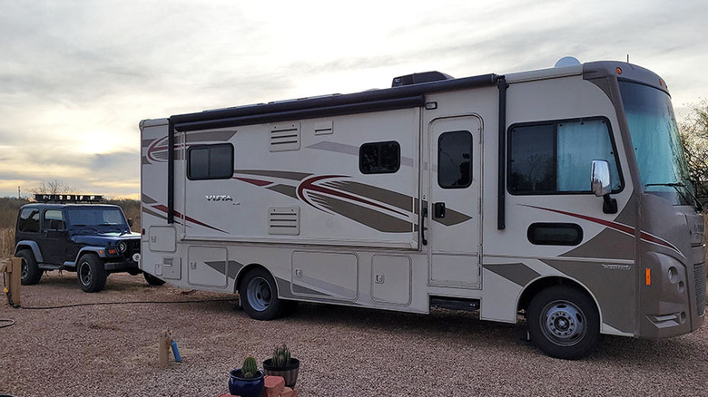 Winnebago RV towing a Jeep