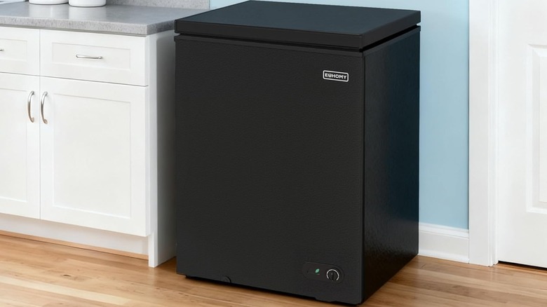 A black chest freezer in a kitchen.