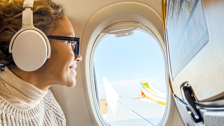 Woman using headphones on flight