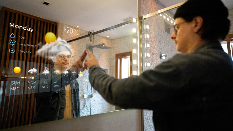 Man using smart mirror in bathroom