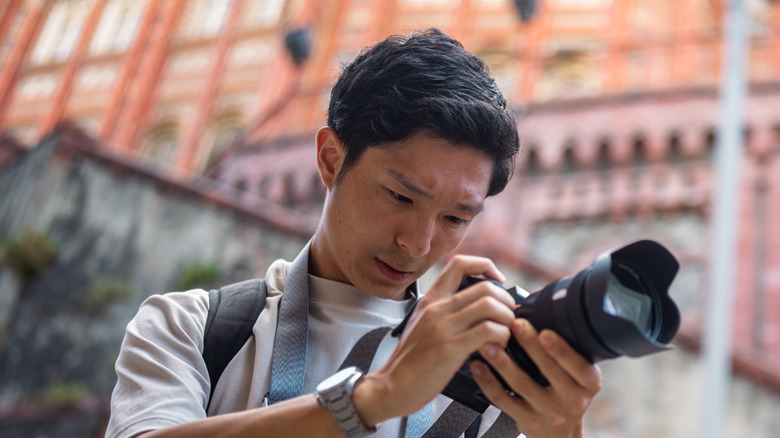 Person using DSLR camera