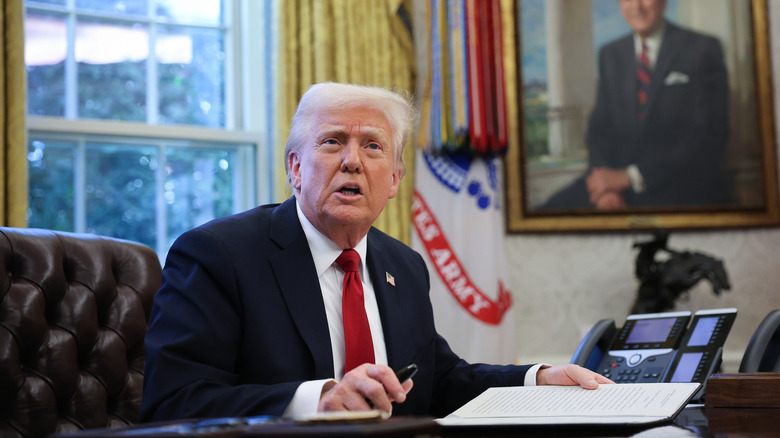U.S. President Donald Trump signs an executive order imposing a 25% tariff on all foreign-made auto parts on March 26, 2025