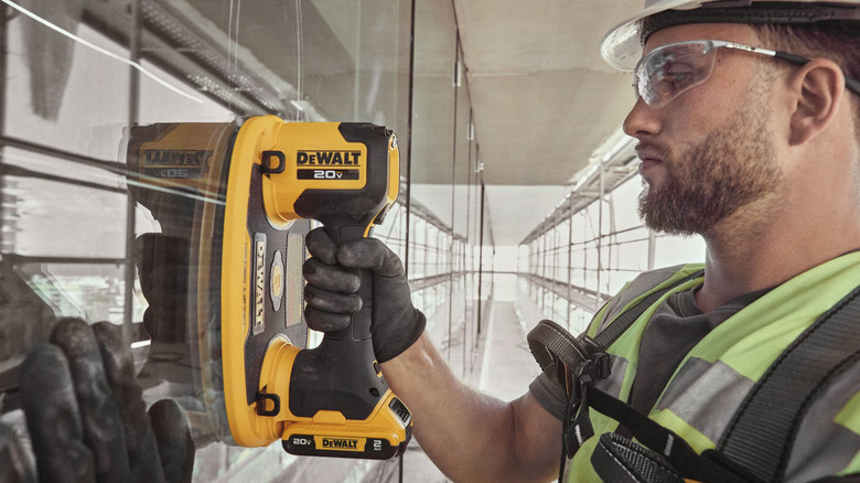 Person using DeWalt 20V Max Grabo Lifter on glass