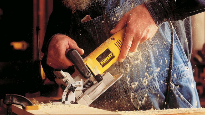 Person wearing overalls using DeWalt 6.5-amp Plate Joiner